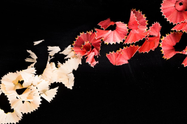 Colourful shavings from pencil on black table