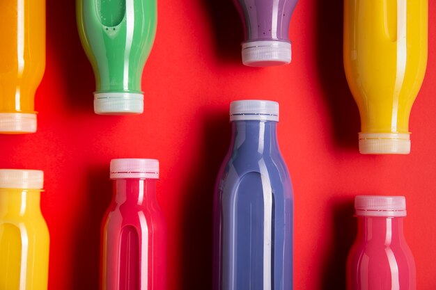 Colourful smoothies on red background