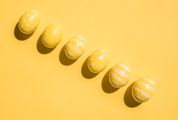 Colourful yellow Easter eggs on table