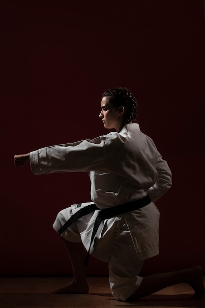 Free photo combat pose of woman in white karate uniform