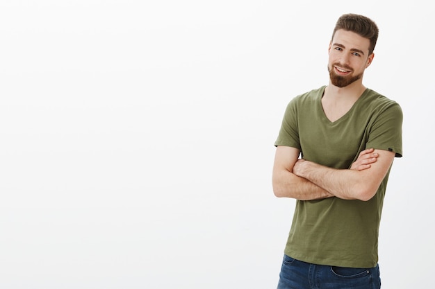 Come on, quit joking, let get to business. Portrait of handsome enthusiastic bearded guy in confident pose cross hands against body and smirking delighted, assured over white wall