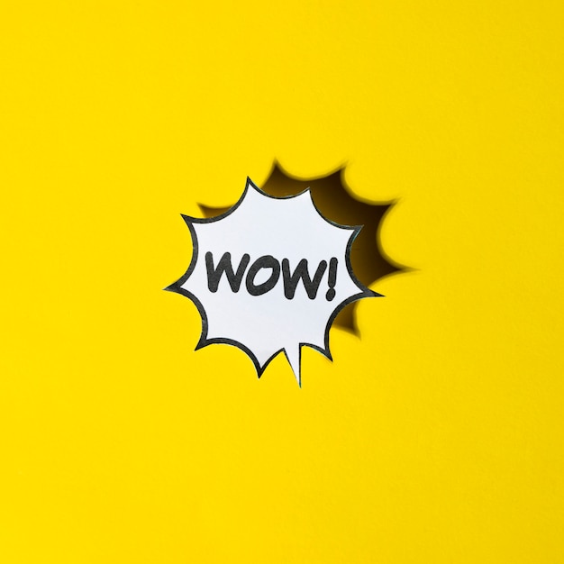 Free photo comic cartoon speech bubble for wow emotions on yellow backdrop