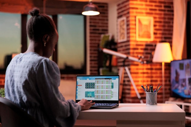 Free Photo company bookkeeper analyzing financial statistics on laptop screen, corporate accounting service concept. business analyst looking at diagrams and charts on computer in modern workspace