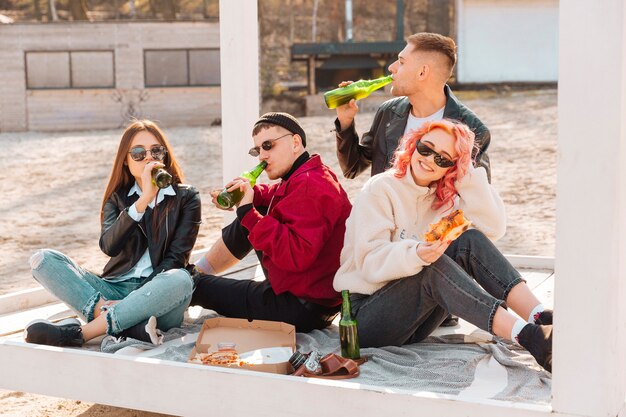 Company of smiling young friends on picnic