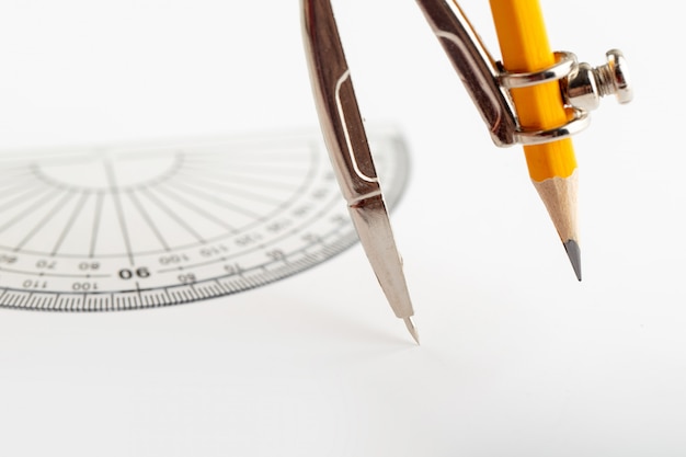 Free photo compass for drawing and drafting isolated with pencil on white desk