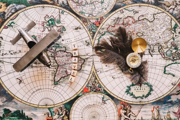 Compass and feathers near travel writing and plane