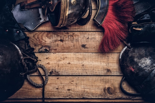 Free photo complete combat equipment of the ancient greek warrior on a wooden boards background.