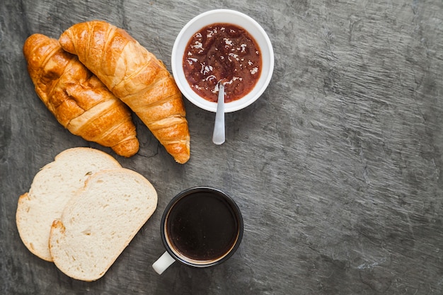 Composed bakery with coffee and marmalade