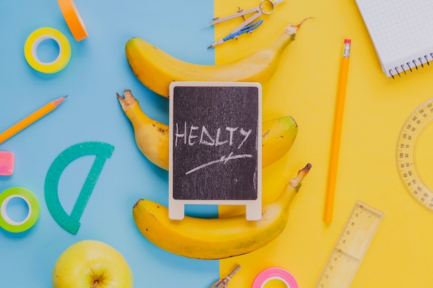 Free photo composed bananas with school kit