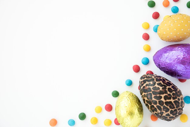 Composition of chocolate eggs and bright candies