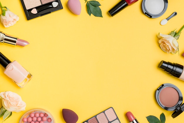 Free photo composition of cosmetics with copy space on yellow background