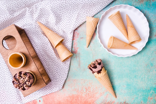 Free photo composition of empty wafer cups and ice cream in waffle cones