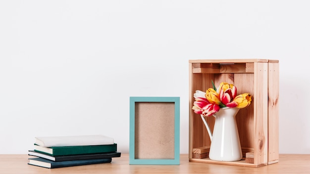 Composition of flowers and books with frame