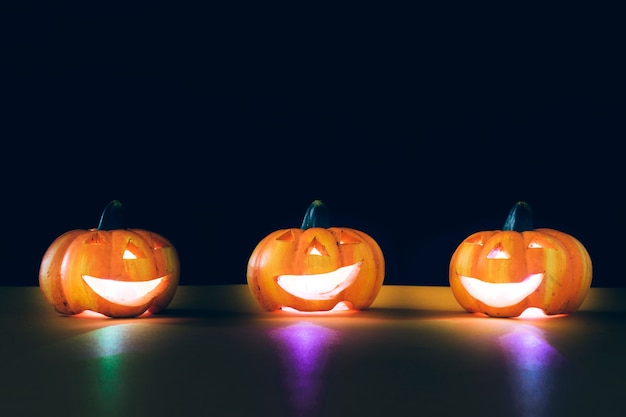 Free Photo composition for halloween with three illuminated pumpkins