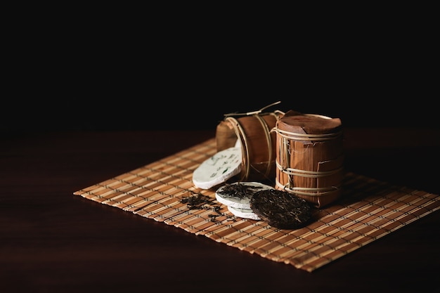 The composition of packed chinese puer tea on a bamboo mat.