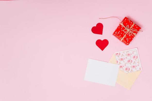 Free photo composition of present box near ornament hearts and envelope