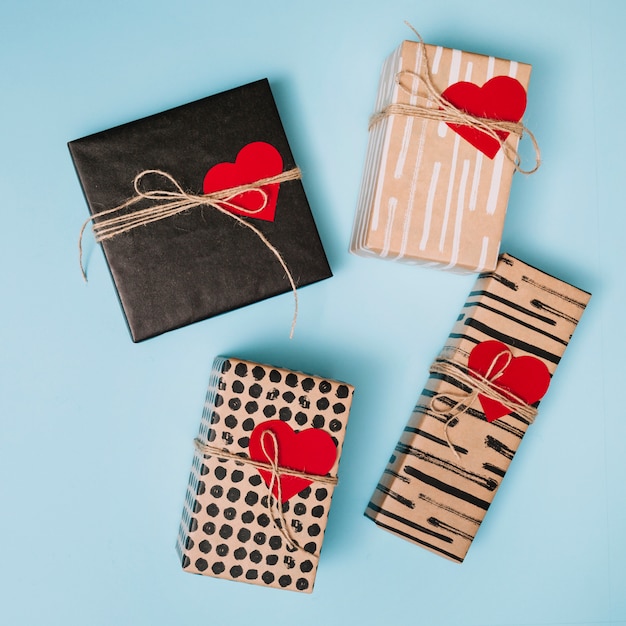 Composition of present boxes in sweetie papers with decorative paper hearts