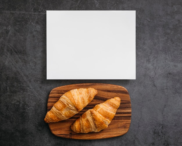 Free photo composition of tasty breakfast croissants with empty card