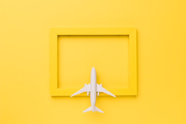 Composition of toy plane on yellow frame