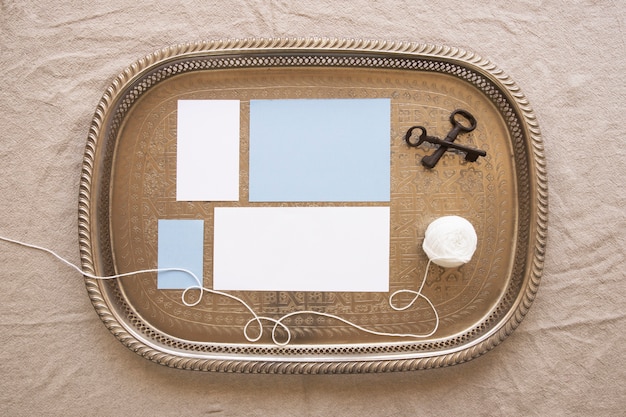 Free Photo composition tray with papers and thread