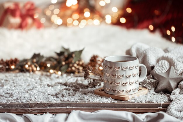 Composition with christmas cup with hot drink on blurred abstract background copy space.