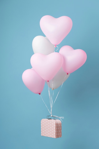 Composition with cute heart balloons in a box