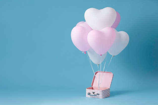 Free photo composition with cute heart balloons in a box