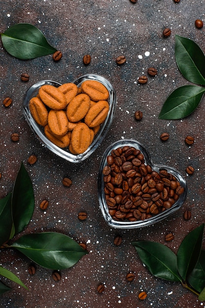 Free photo composition with roasted coffee beans and coffe bean shaped cookies