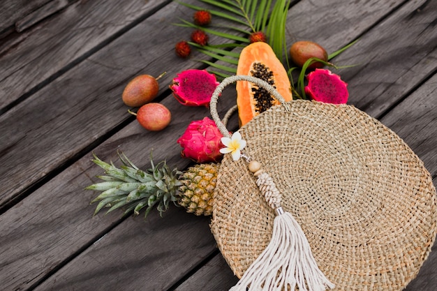 Composition with tropical fruits in straw bag