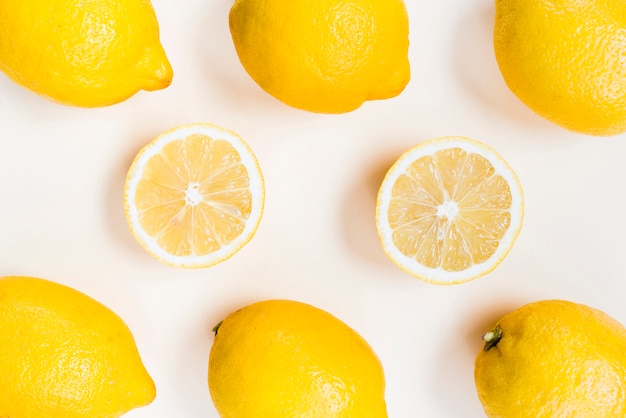 Free photo composition of yellow lemons on white background