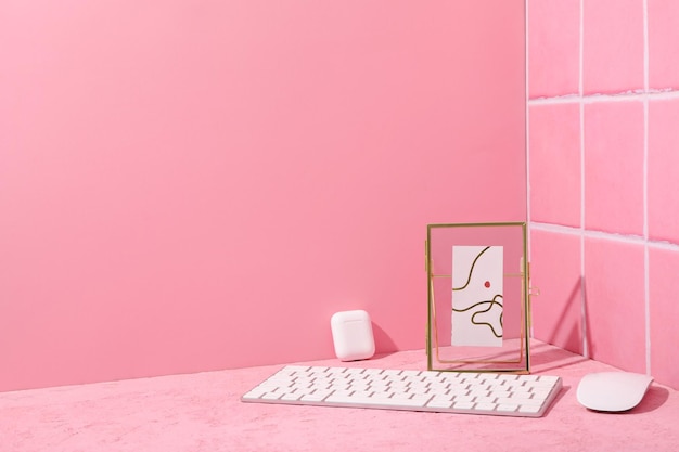 Free photo computer keyboard with mouse and cassette on a pink background