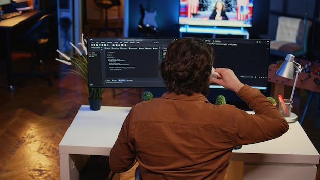 Free photo computer scientist at home office desk writing binary code and drinking coffee