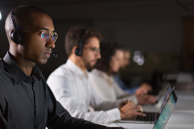 Concentrated African American call center operator working