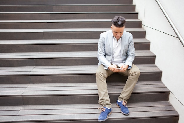 Concentrated Business Man Texting Message on Phone