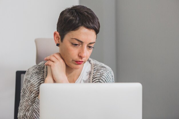 Concentrated businesswoman looking at her computer