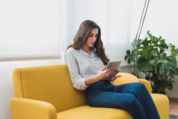 Concentrated businesswoman working with her tablet