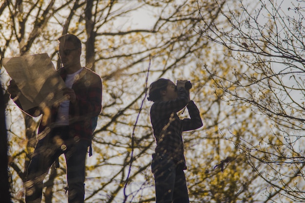 Free photo concentrated hikers with map and binoculars