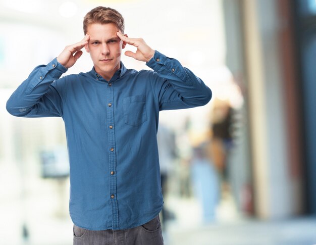 Concentrated man with hands on temples