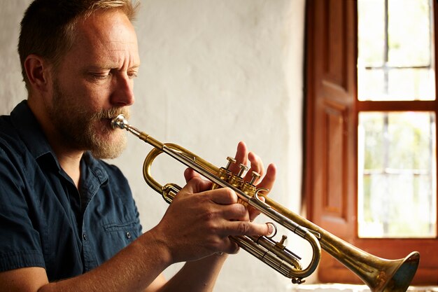 Concentrated musician playing his instrument