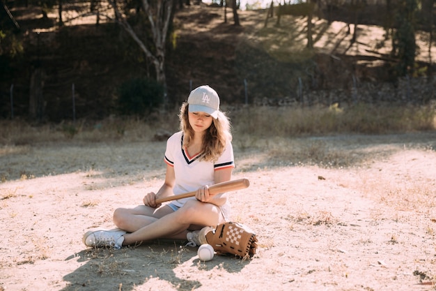 Concentrated teen student with baseball bet