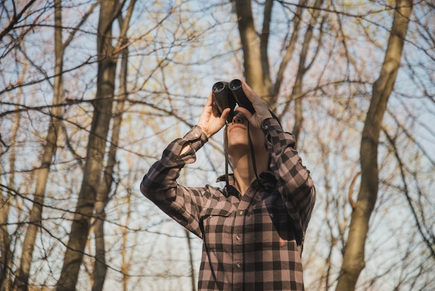 Free Photo concentrated traveler using binoculars