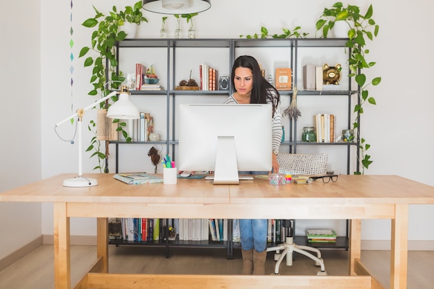 Free photo concentrated young woman working with computer