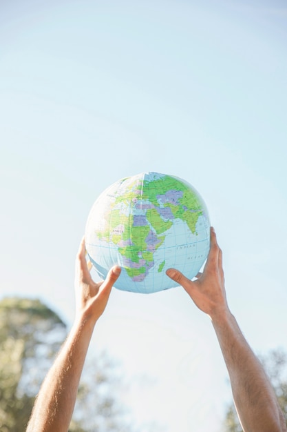 Free photo concept hands holding planet model