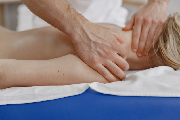 Free photo concept of healthcare and female beauty. masseuses make a massage of a girl. woman in a spa salon.