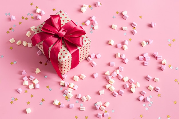 Free Photo the concept of valentine's day. gift box with red bow on pink.