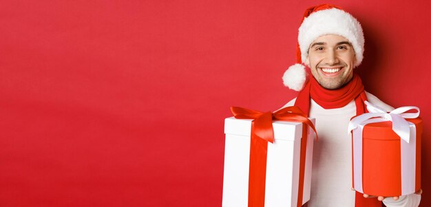 Concept of winter holidays christmas and lifestyle closeup of smiling handsome guy in santa hat and ...