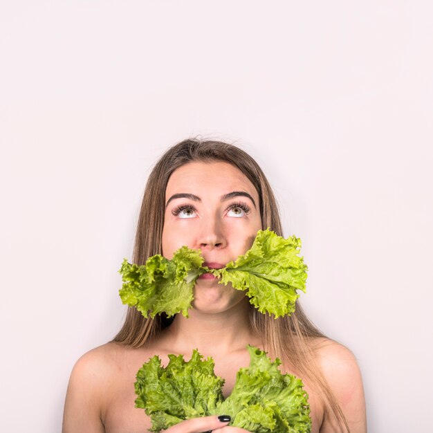 Concept of young woman eating fresh salad