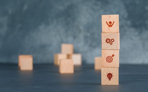 Free photo conceptual of business with wooden blocks column with icons.