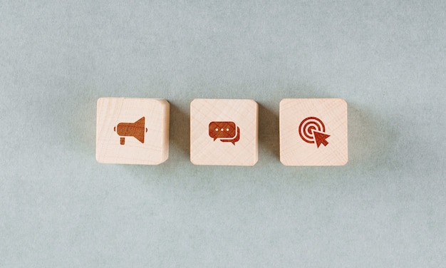 Conceptual of target with wooden blocks with red icons.