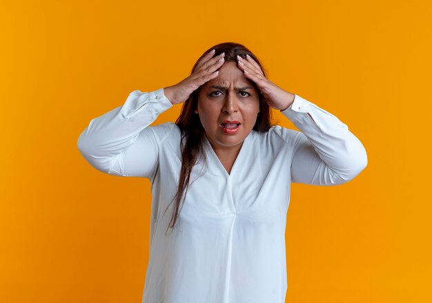 Concerned casual caucasian middle-aged woman grabbed head 